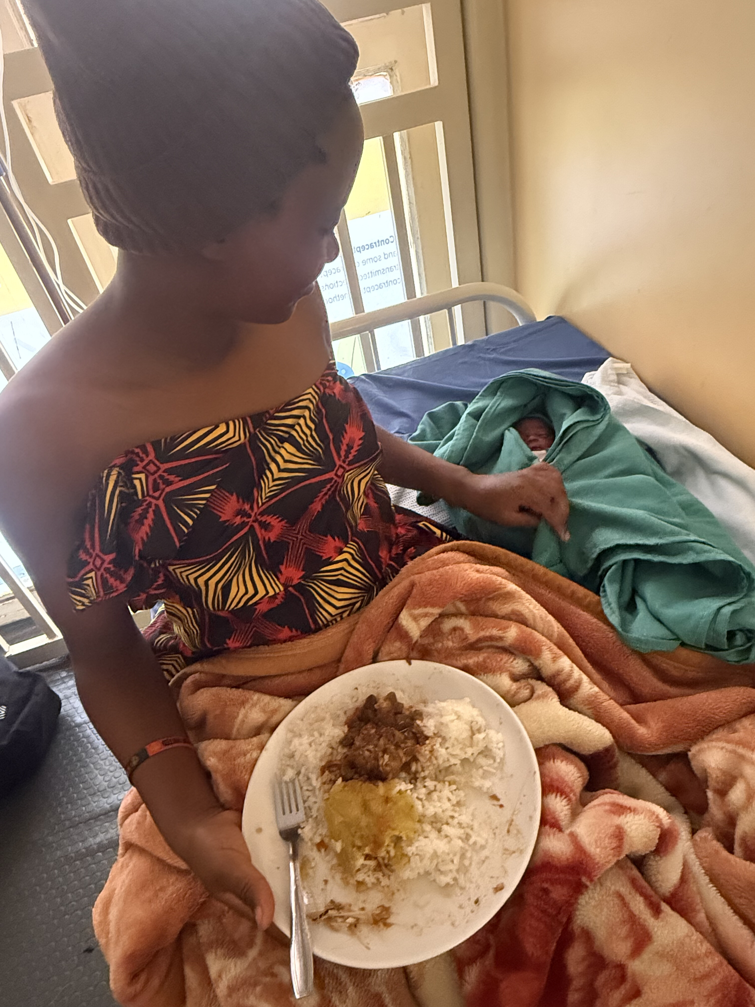 A mother eating a meal while receiving care at Grace Care