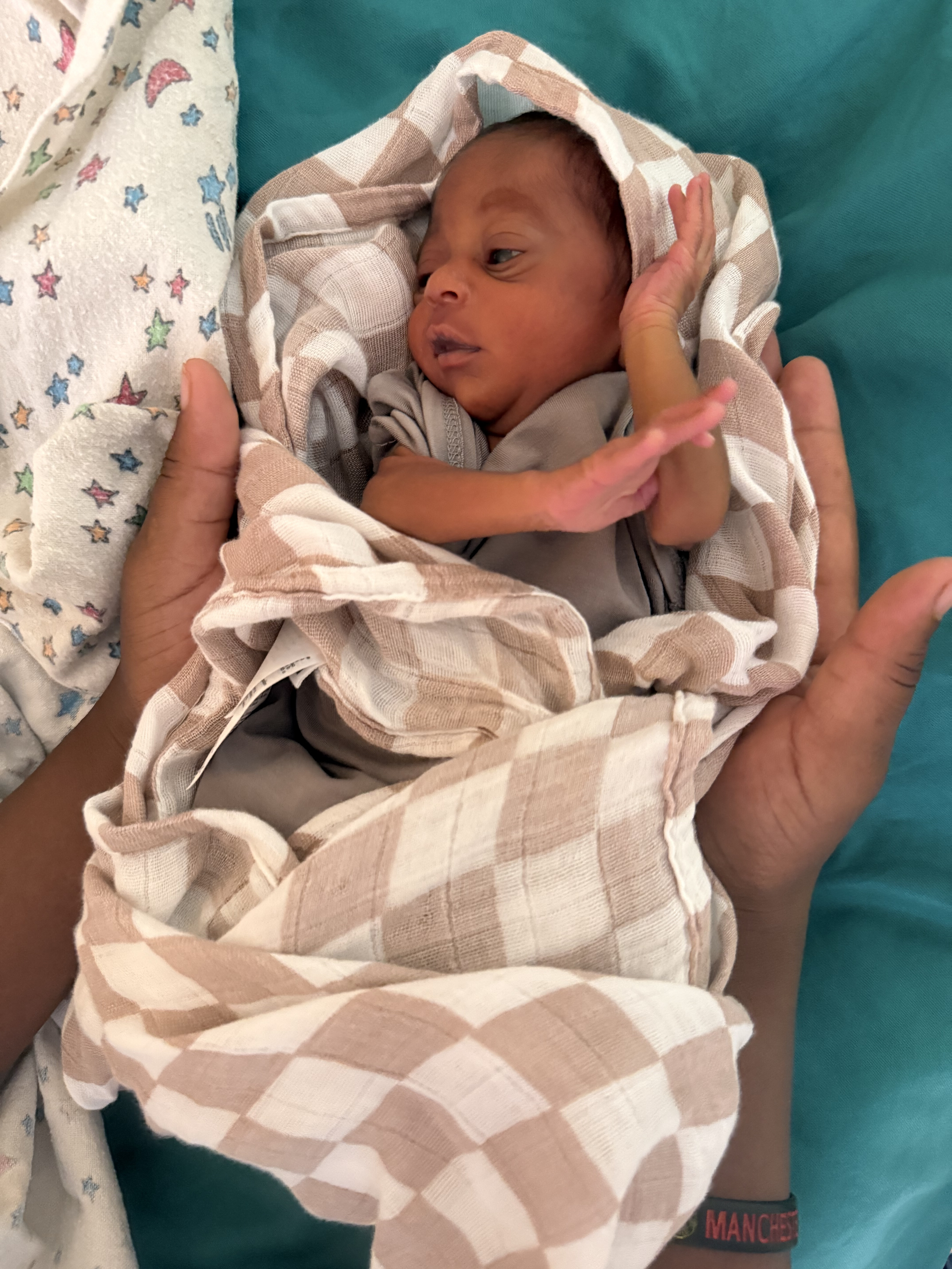 A newborn baby receiving care